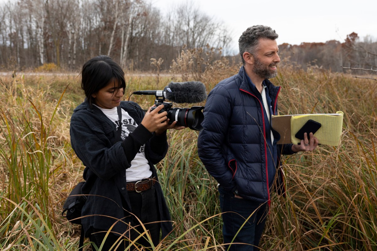 Wisconsin Watch audio/video producer Trisha Young and investigative reporter Bennet Goldstein in a field