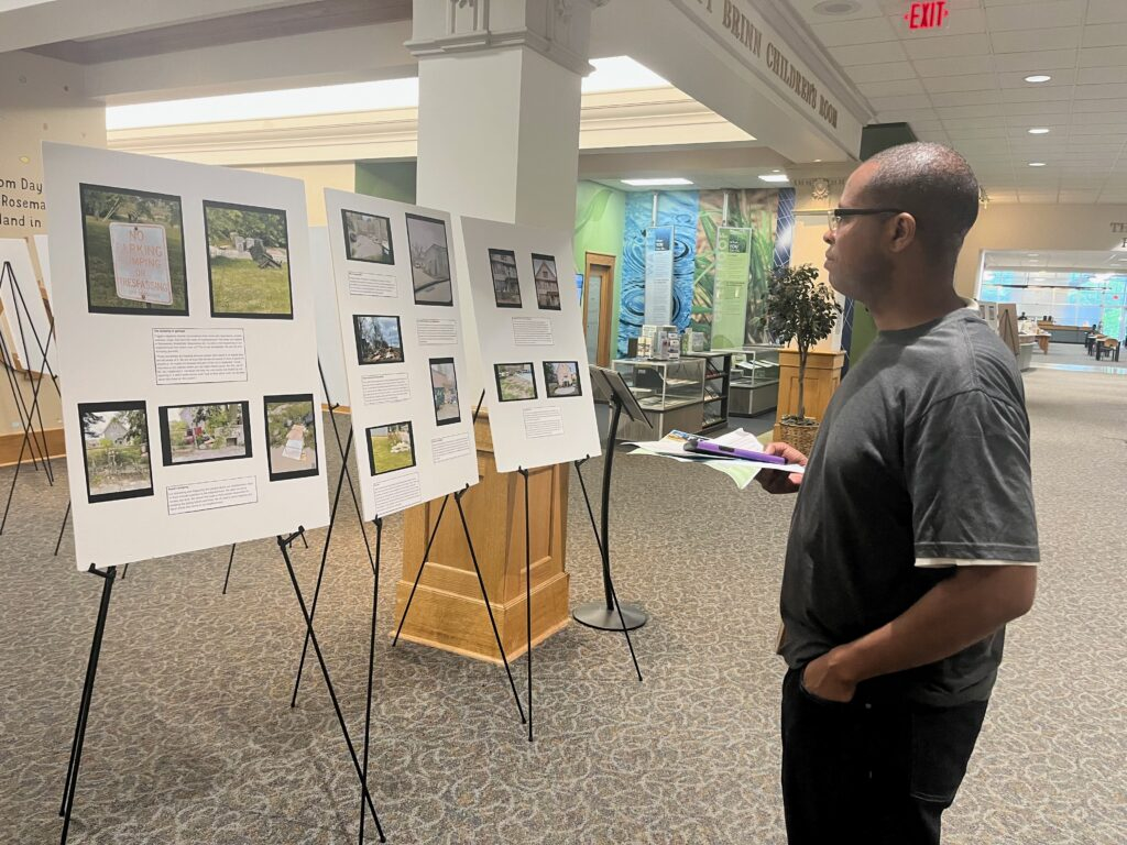 A man looks at photos on display.