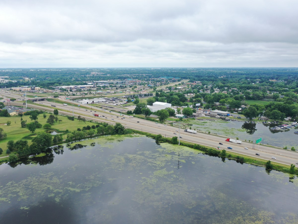 Aerial view of vehicles on a highway bridge crossing water